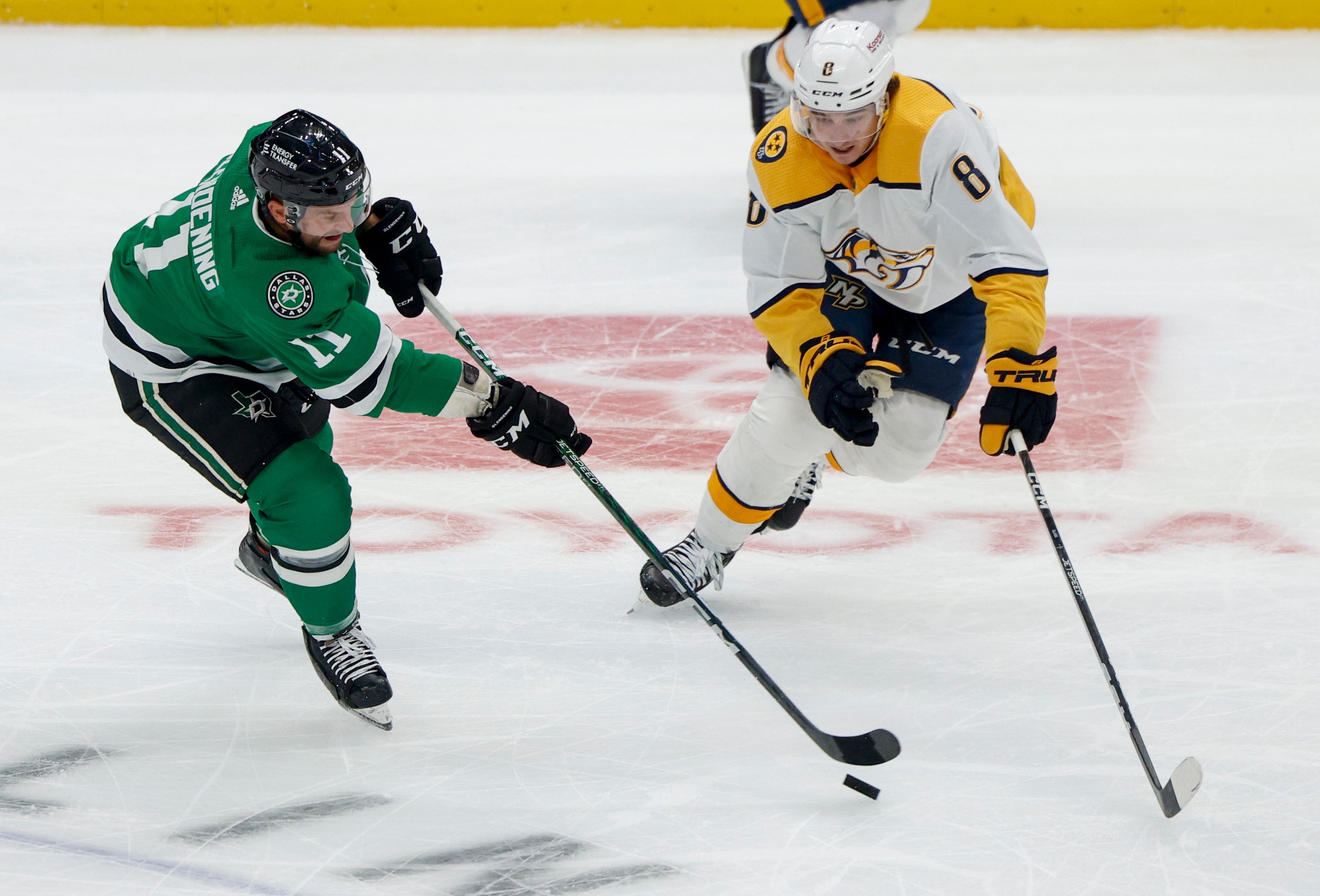 Dallas Stars center Luke Glendening (11) passes the puck ahead of Nashville Predators center...