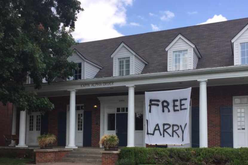 A "Free Larry" sign hangs under an SMU fraternity house Tuesday morning.
