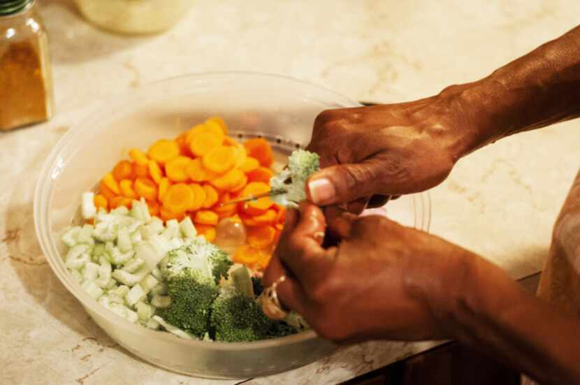 Re Richardson cooks a vegan meal with  vegetables at her home.