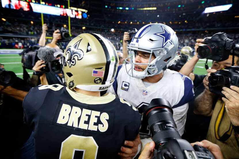 FILE - Saints quarterback Drew Brees (9) congratulates Cowboys quarterback Dak Prescott (4)...