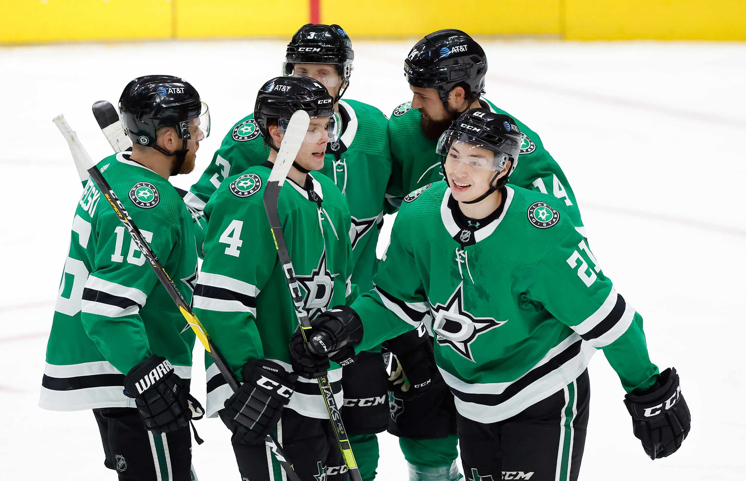 Dallas Stars left wing Jason Robertson (21) is congratulated by teammates after scoring a...