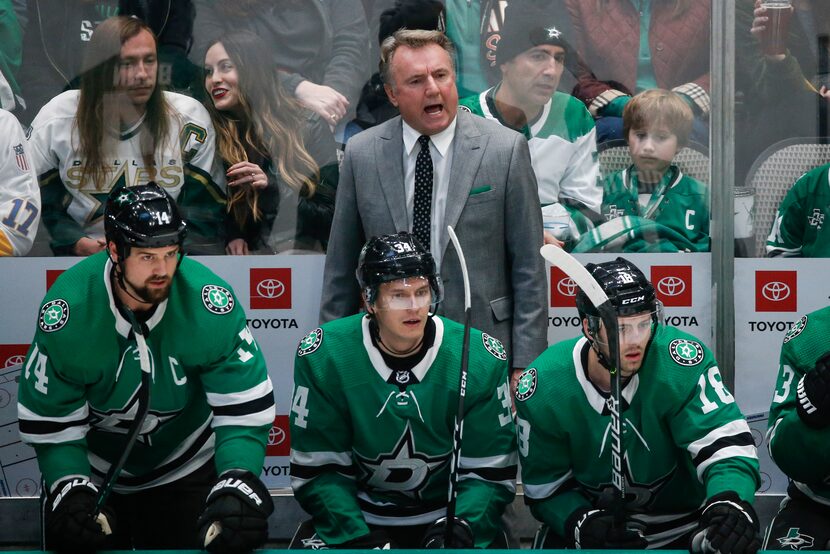 Dallas Stars interim head coach Rick Bowness works the bench during the first period of a...