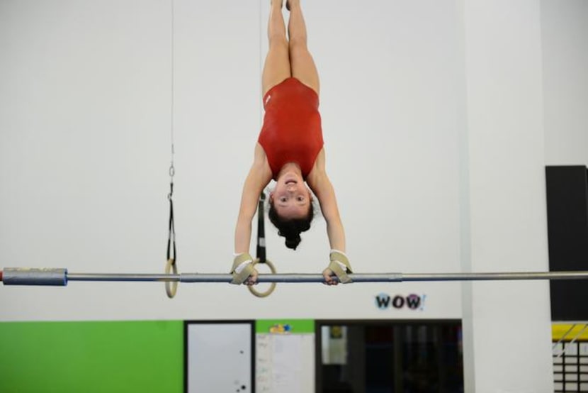 
 McCauley Harrington, 8, trains on the uneven bars.
