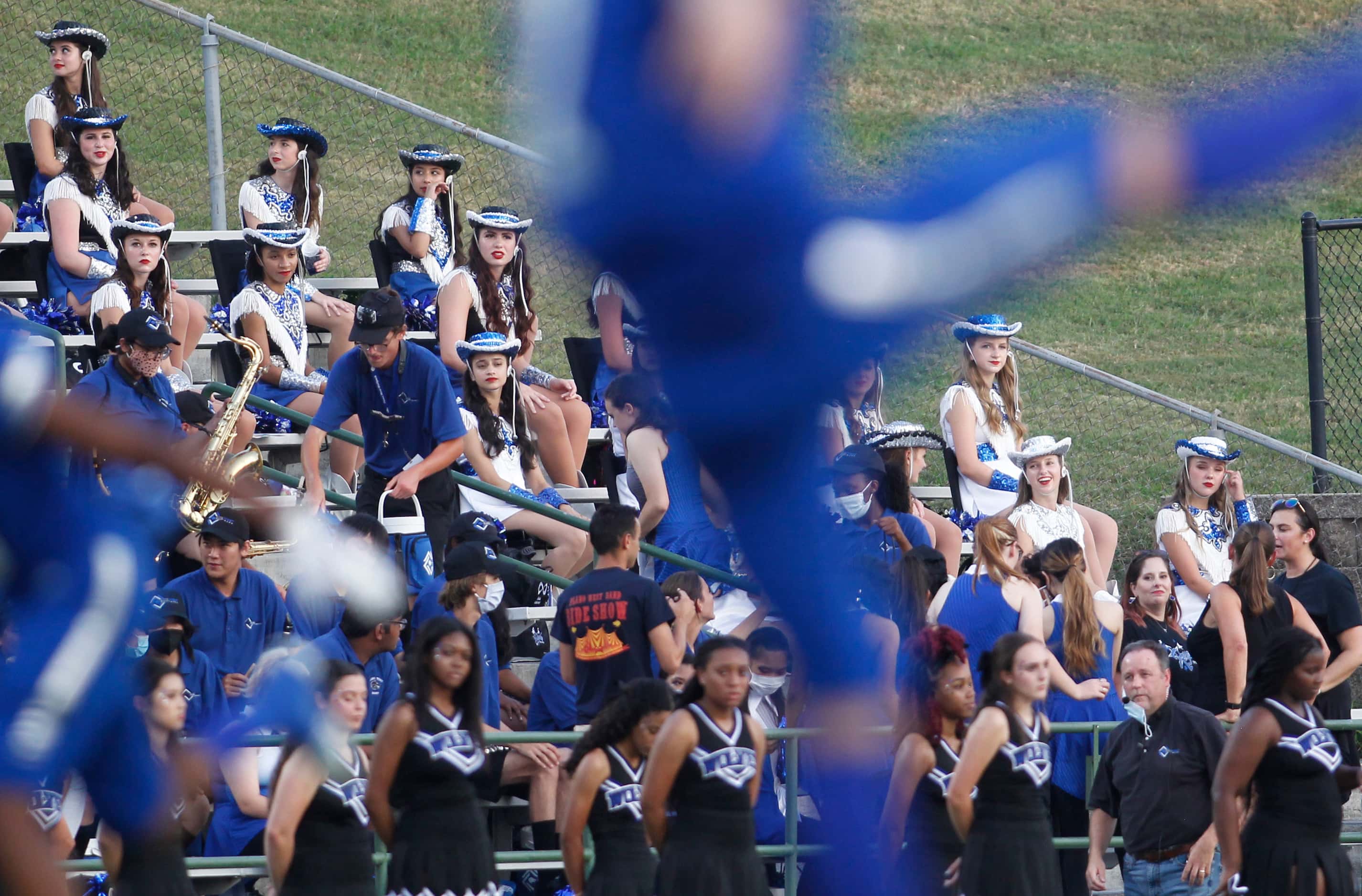 Plano West drill team and band members watch first quarter action of the North Mesquite...