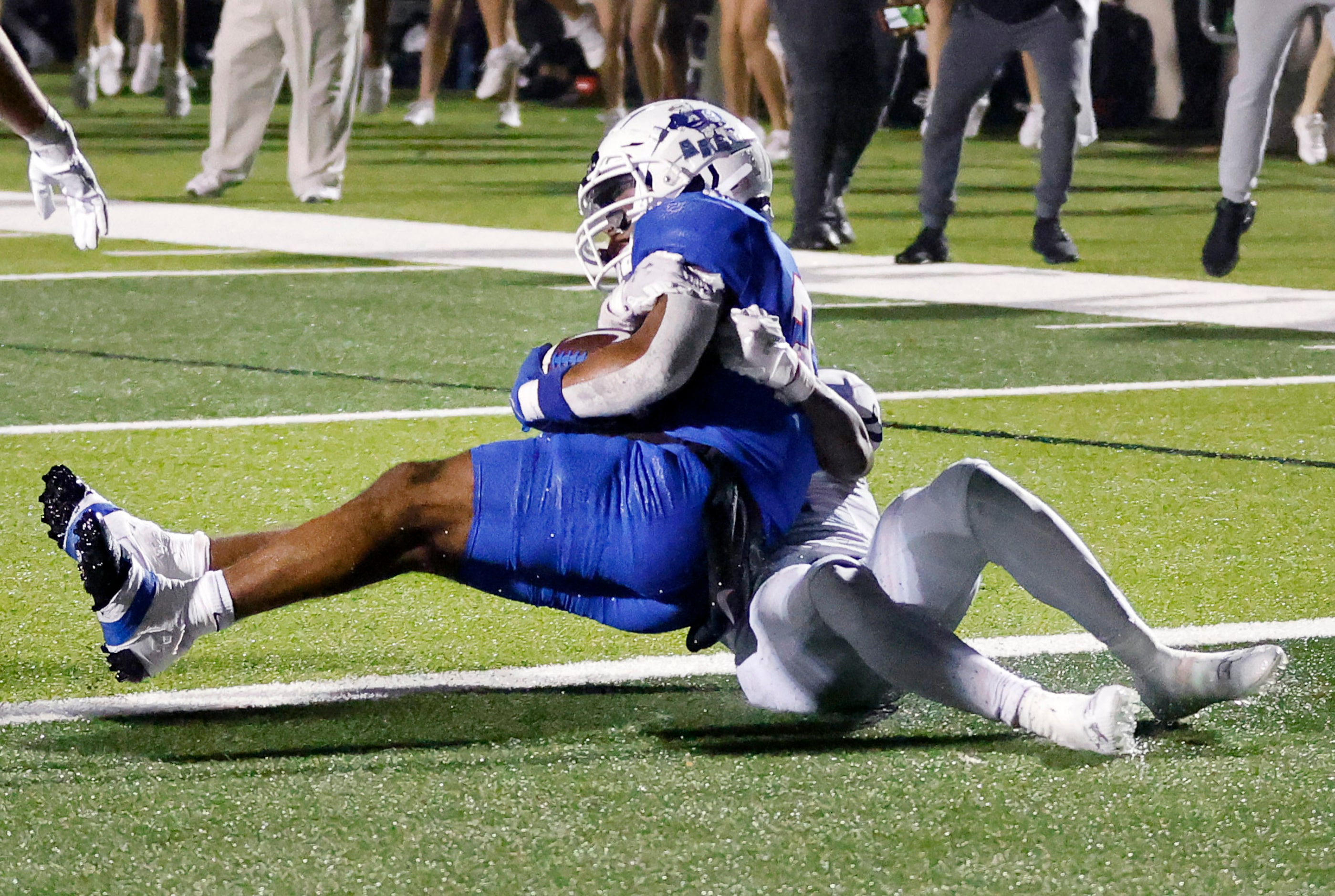 Allen running back Micah Ellis (27) carried Arlington Martin defensive back Zavien...