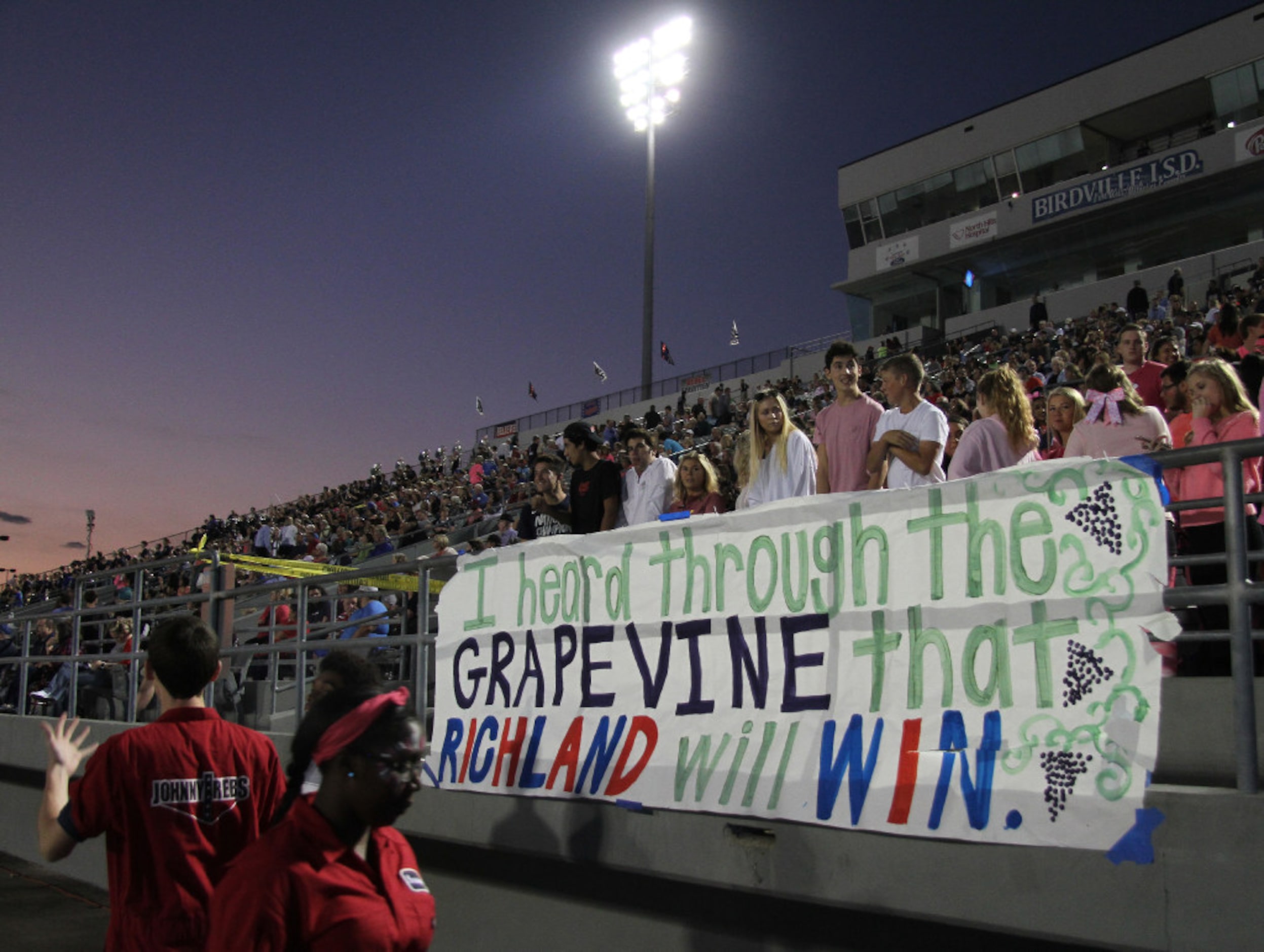 Richland fans post a message via a large sign along the team sidelines prior to the start of...