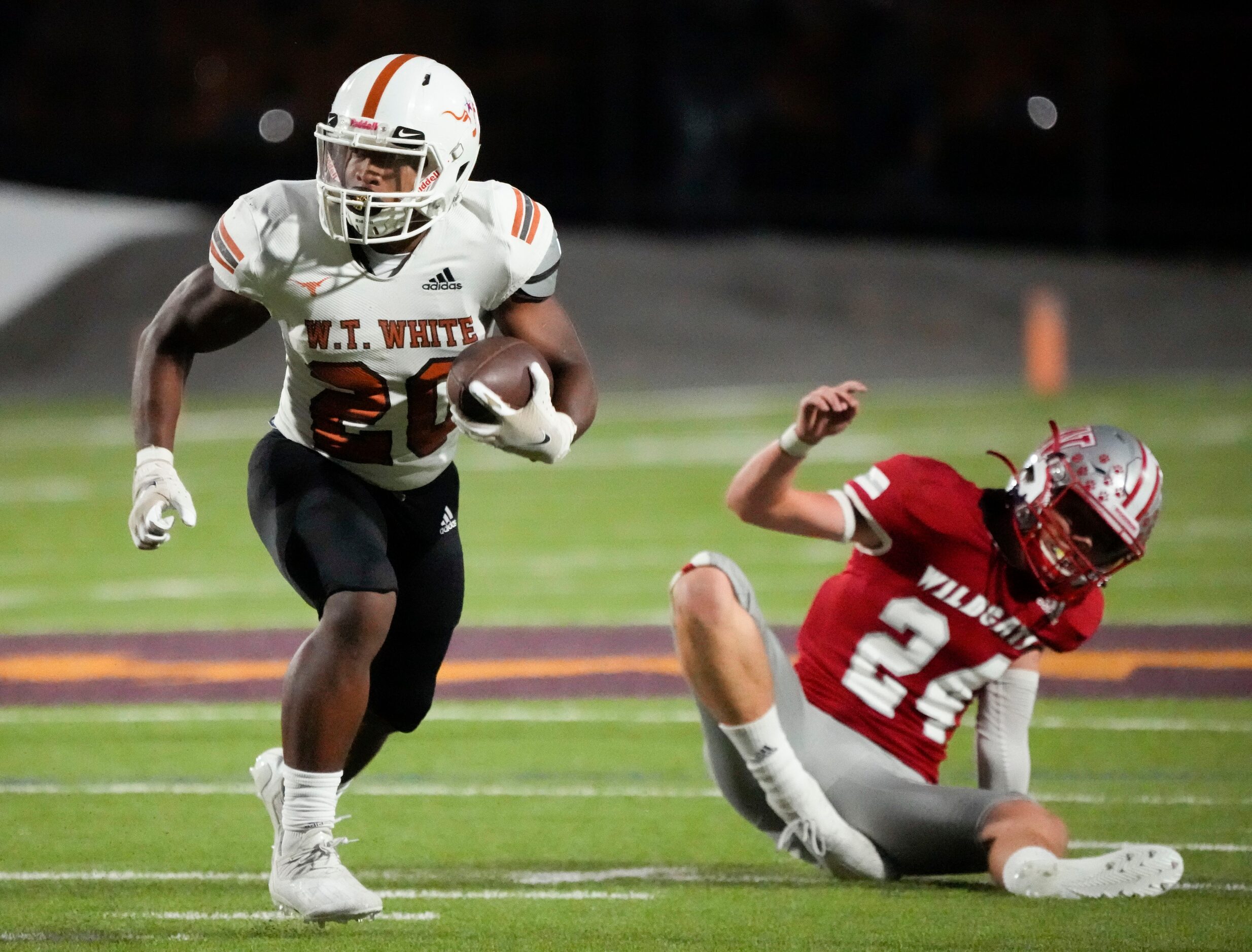 W. T. White Elijah Edwards (20) shakes a tackle by Woodrow Wilson junior linebacker Jake...