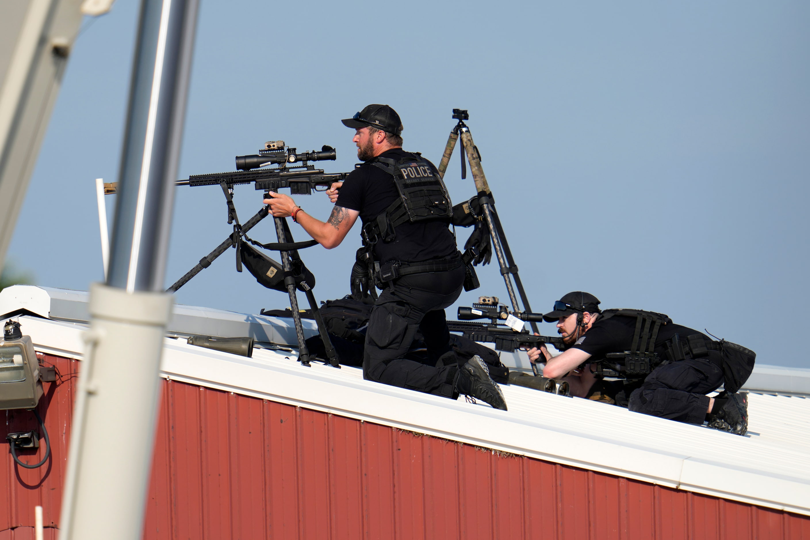 Police snipers return fire after shots were fired while Republican presidential candidate...