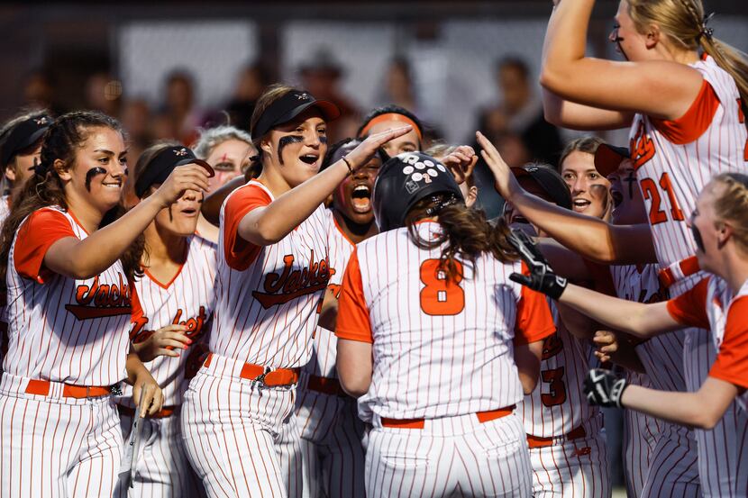 Rockwall’s Laci Larsen (8) is congratulated by teammates after hitting a solo home run...