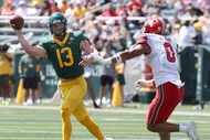Baylor quarterback Sawyer Robertson throws on the run as Utah defensive end Logan Fano...