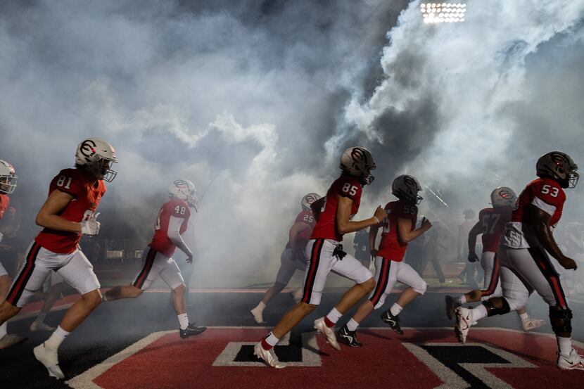 The Coppell Cowboys run on to the field for their Thursday night football game versus Plano...