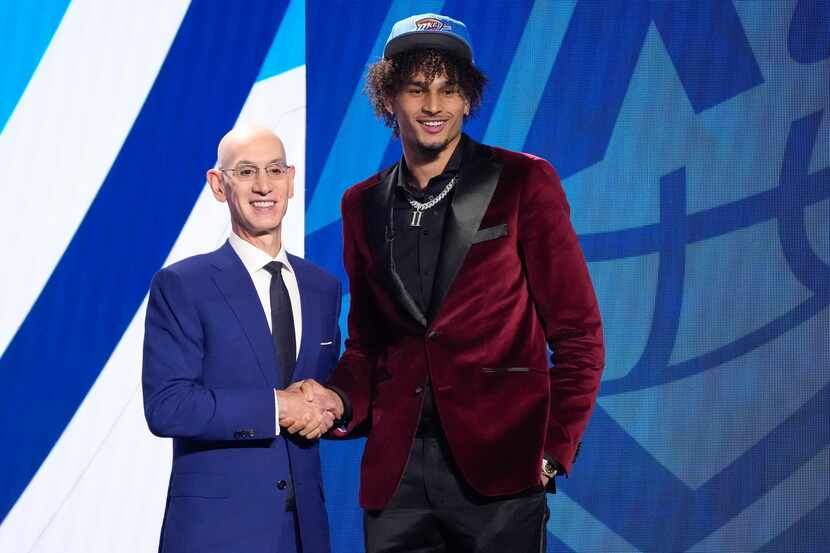 Dereck Lively II poses for a photo with NBA Commissioner Adam Silver after being selected...