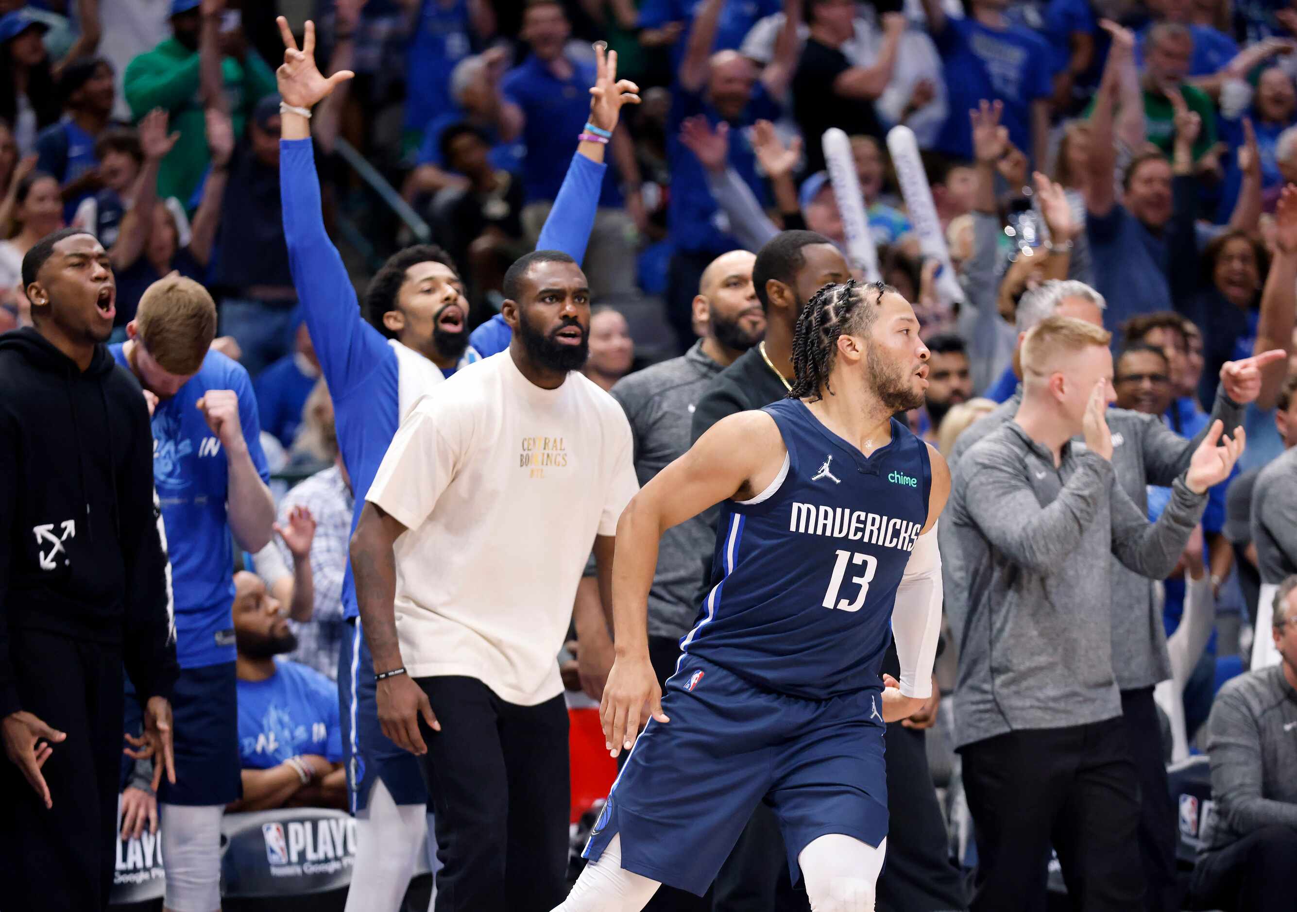 The Dallas Mavericks bench celebrates after guard Jalen Brunson (13) nailed a fourth...