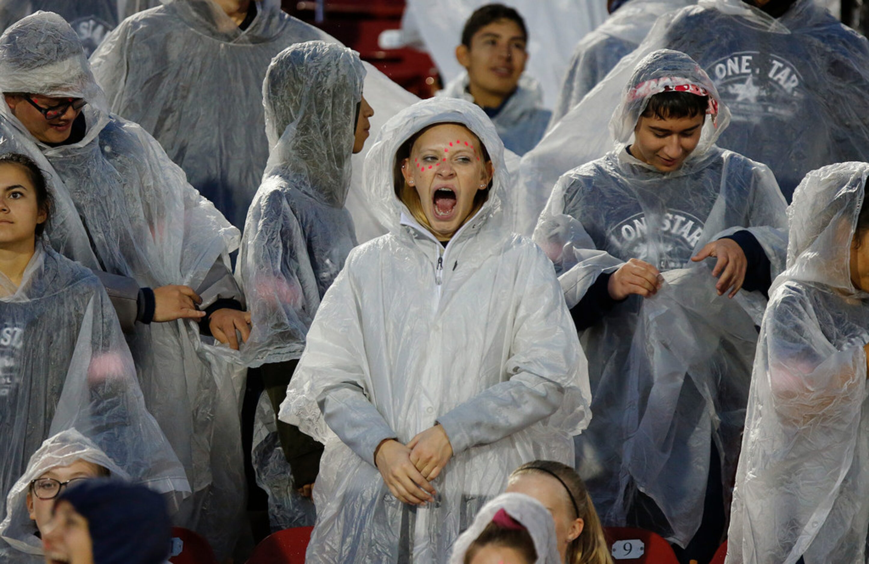 Kayla Gast, who plays flute for the Lone Star High School marching band, catches a yawn...