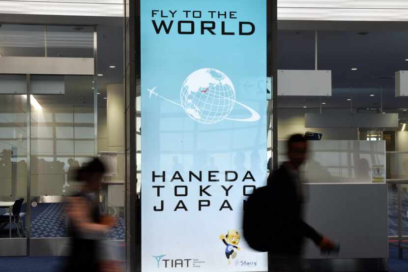  Passengers walk through Haneda International Airport.