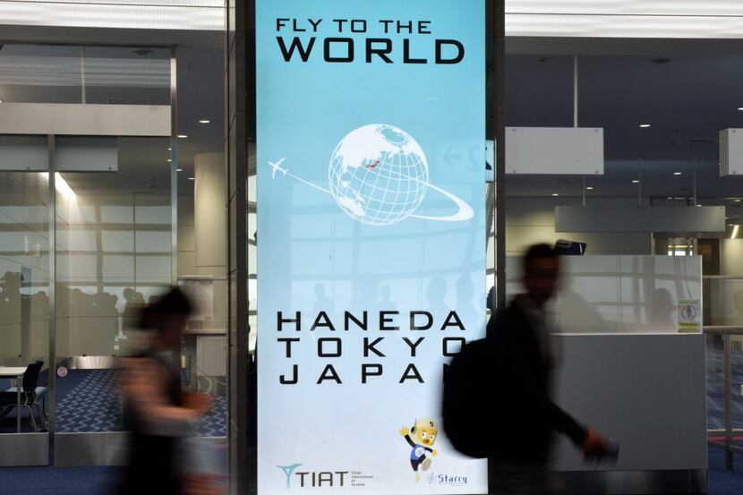  Passengers walk through Haneda International Airport's international terminal in Tokyo, Japan.