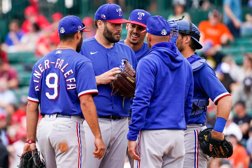 Texas Rangers pitcher Lance Lynn talks with infielder Isiah Kiner-Falefa (9), first baseman...