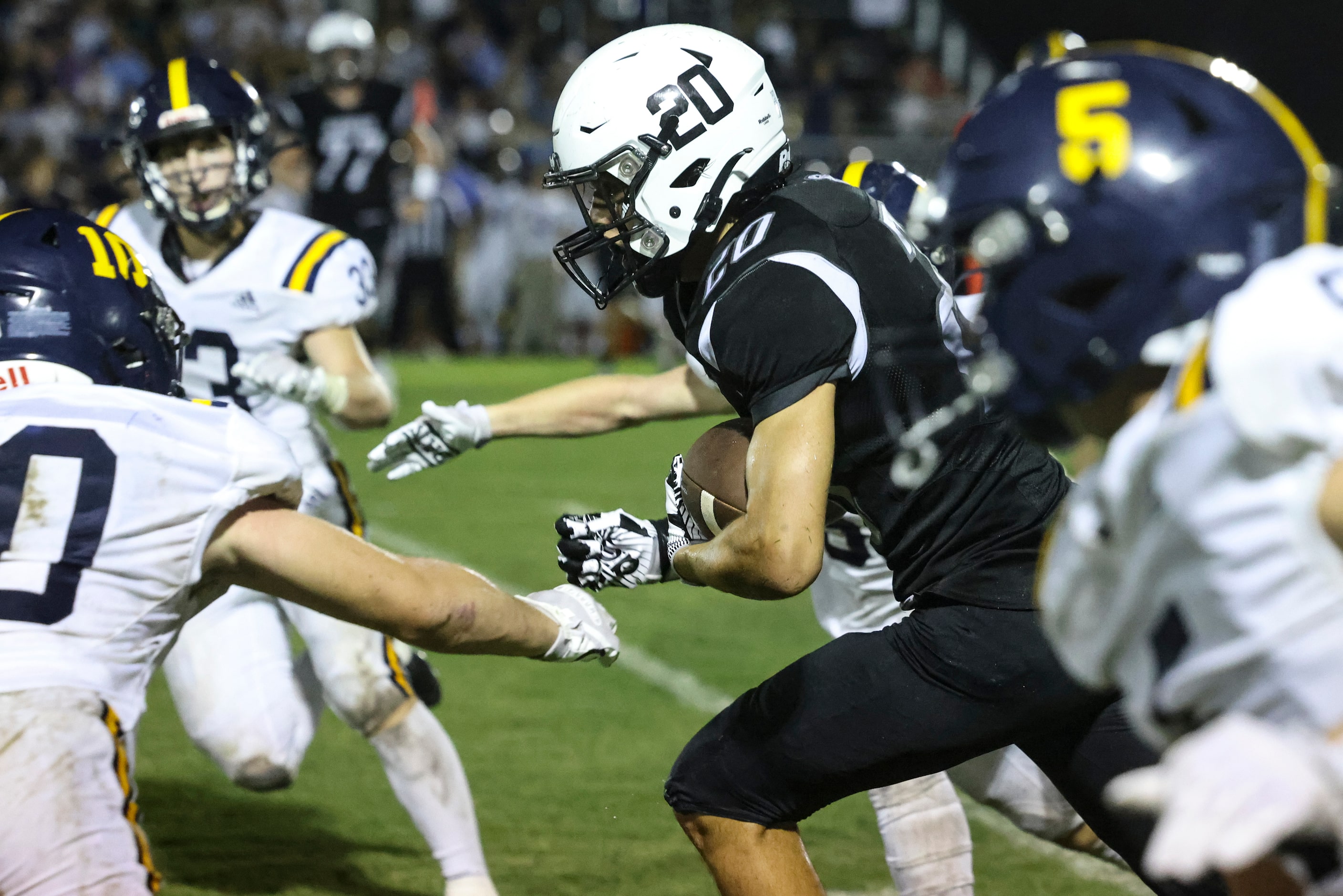 Cistercian Preparatory School Michael Peterman (20) dodges St. Mark's School of Texas...