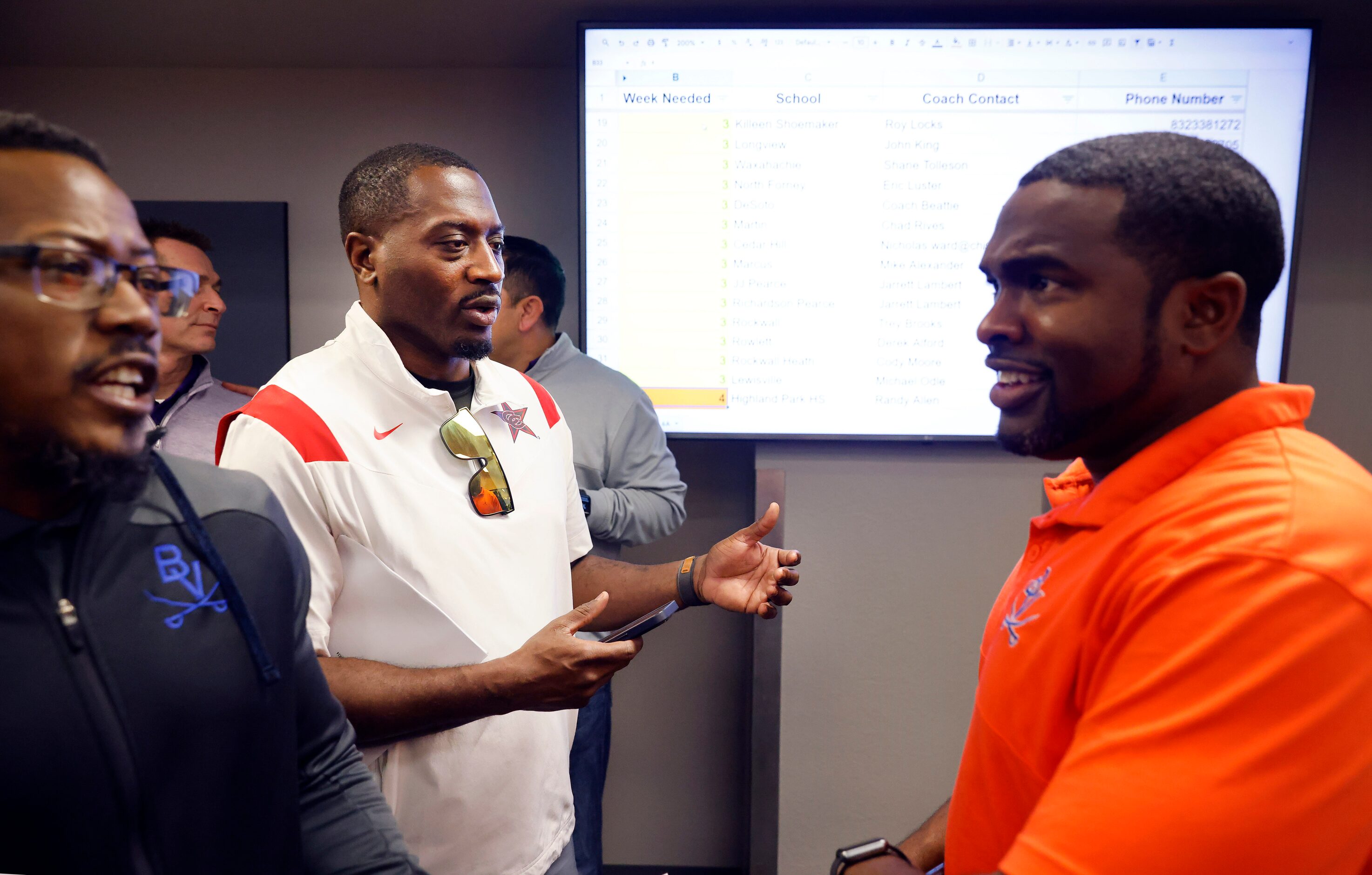 Arlington Bowie head football coach Joseph Sam (right) visits with Coppell head coach...