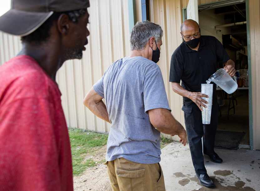 Pastor Chris Simmons hands out ice cold water to Cornerstone clients.