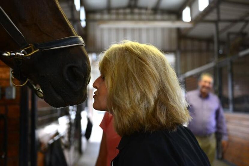 
Head trainer Lisa Blackmon leans in to kiss Irnas before a ride. Blackmon has spent her...