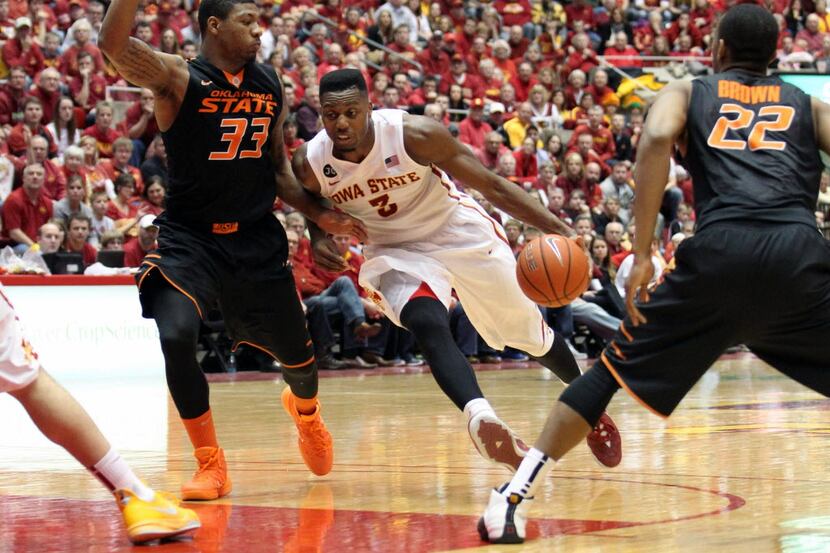 Iowa State Cyclones forward Melvin Ejim (3) is defended by Oklahoma State Cowboys guard...