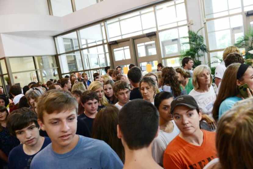 Rockwall High School's incoming freshmen crowd the halls to receive their class schedules on...