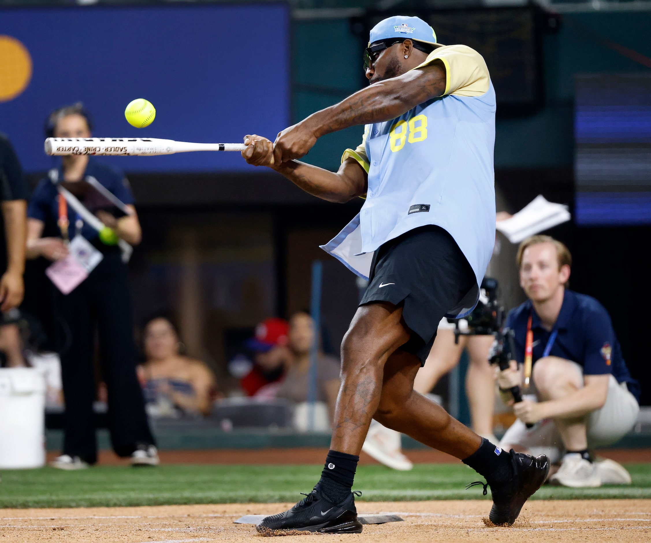 Former Dallas Cowboys player Des Bryant makes contact with the ball as he hits during the...