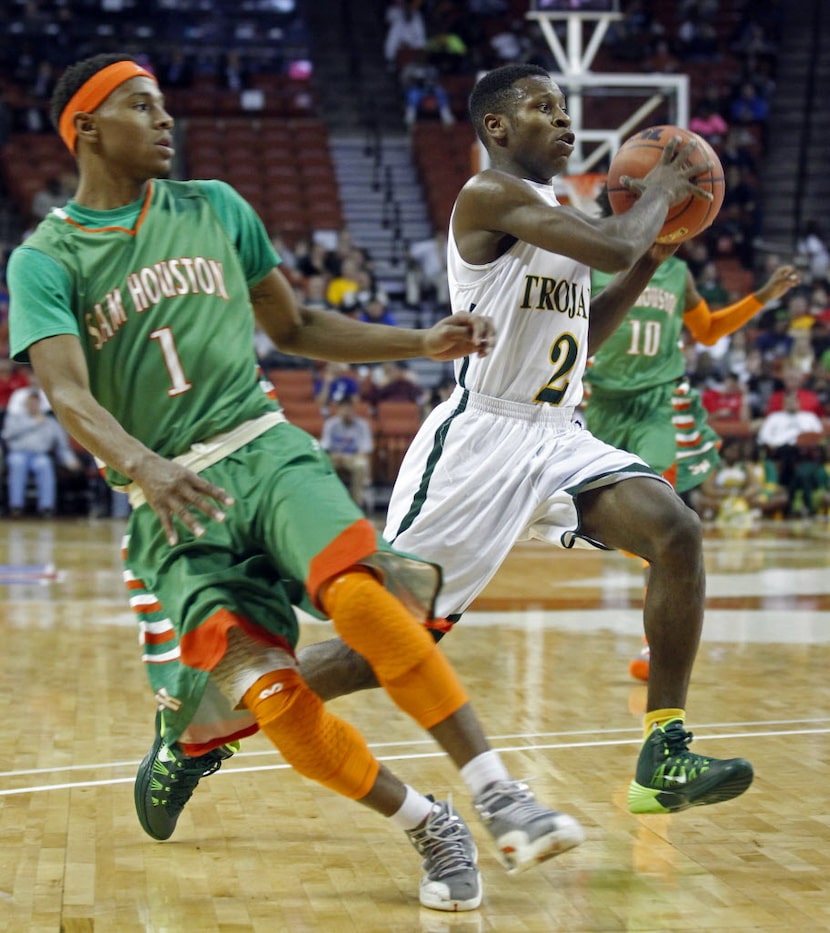 Dallas Madison guard Cameron Bryant (2) drives past San Antonio Houston Jordon Harris (1)...