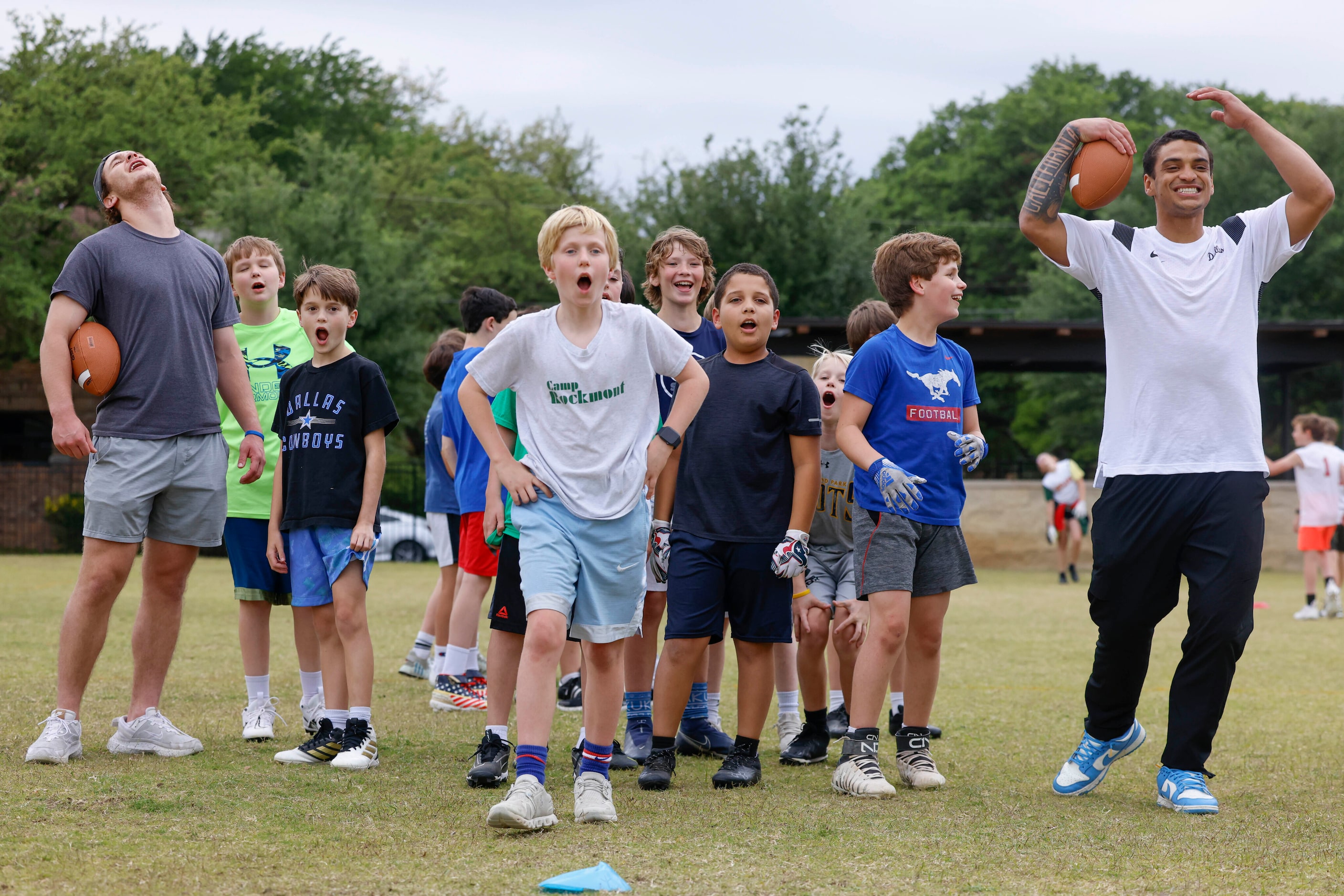 SMU’s Preston Stone (left) and Jake Bailey (right) alongside the kids reacts during a...