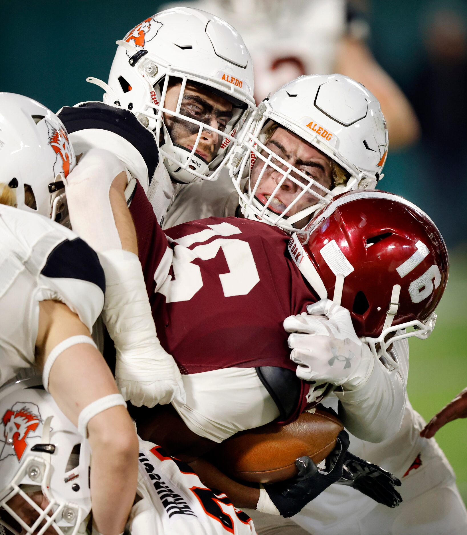 Aledo’s Cooper Kohan (left) and Caden Atwood (right) swarm Red Oak receiver Arvis Battle, Jr...