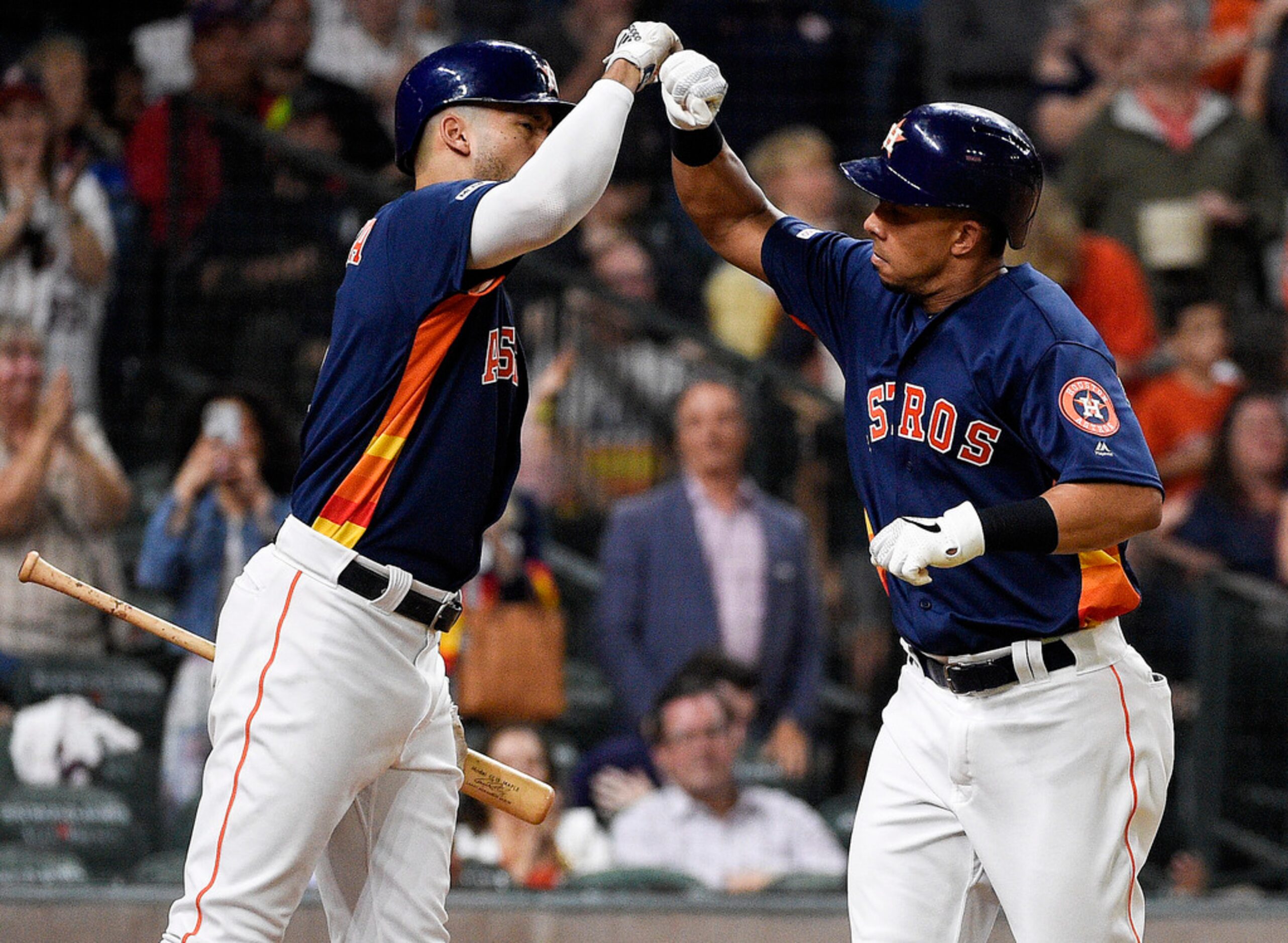 Houston Astros' Michael Brantley, right, celebrates his solo home run off Texas Rangers...