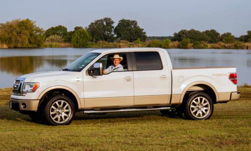 Former President George W. Bush sits in his Ford pickup in Crawford. The 2009 pickup, which...