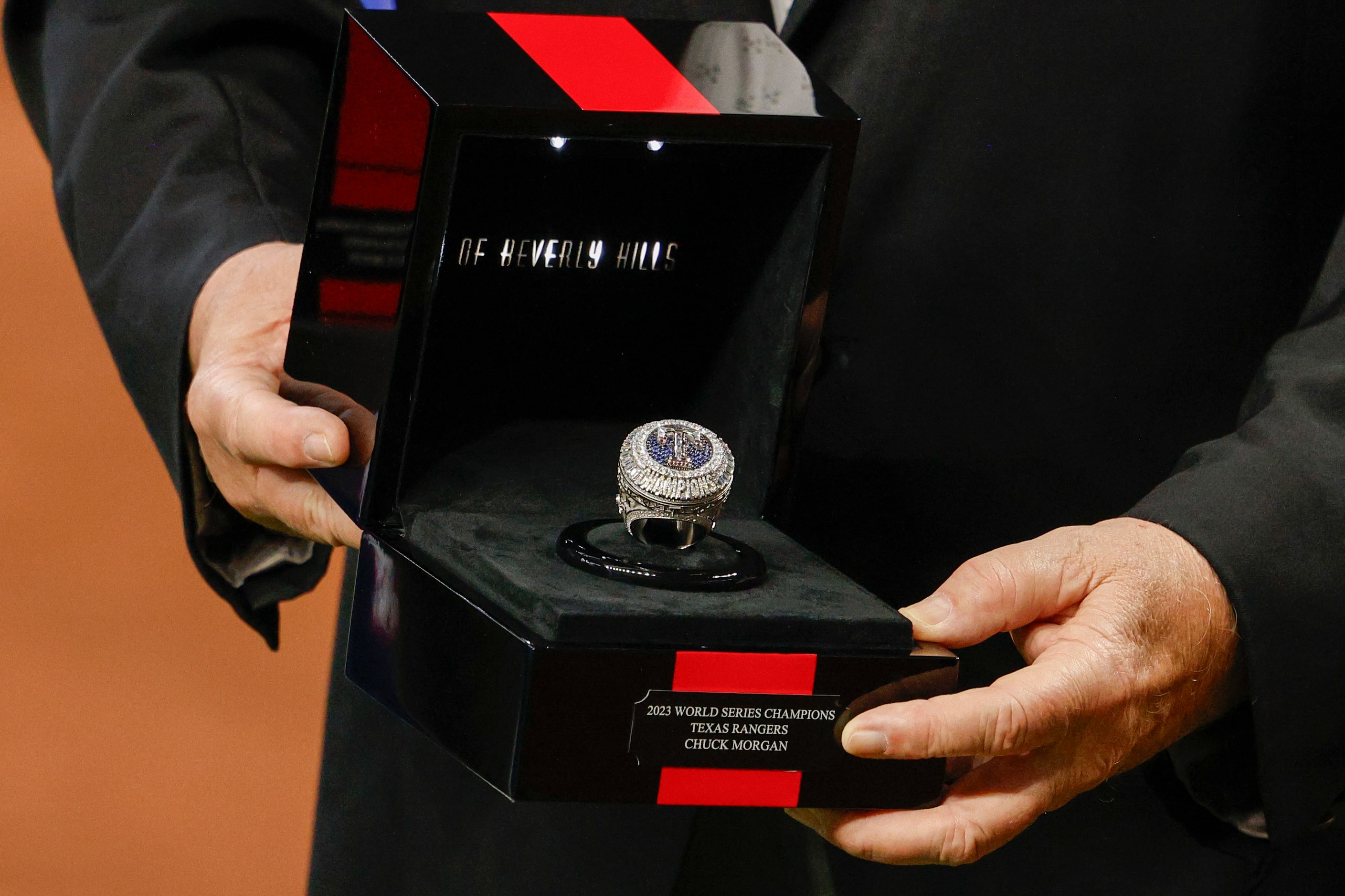 Chuck Morgan, Texas Rangers public address announcer, shows of his World Series championship...