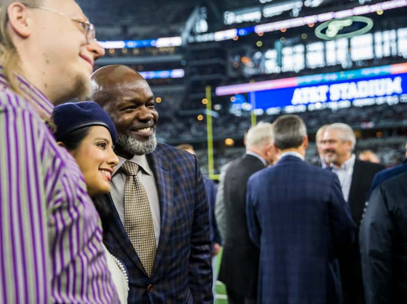 NFL Hall of Famer Emmitt Smith, center, poses for a photo with Dallas Cowboys fans before...