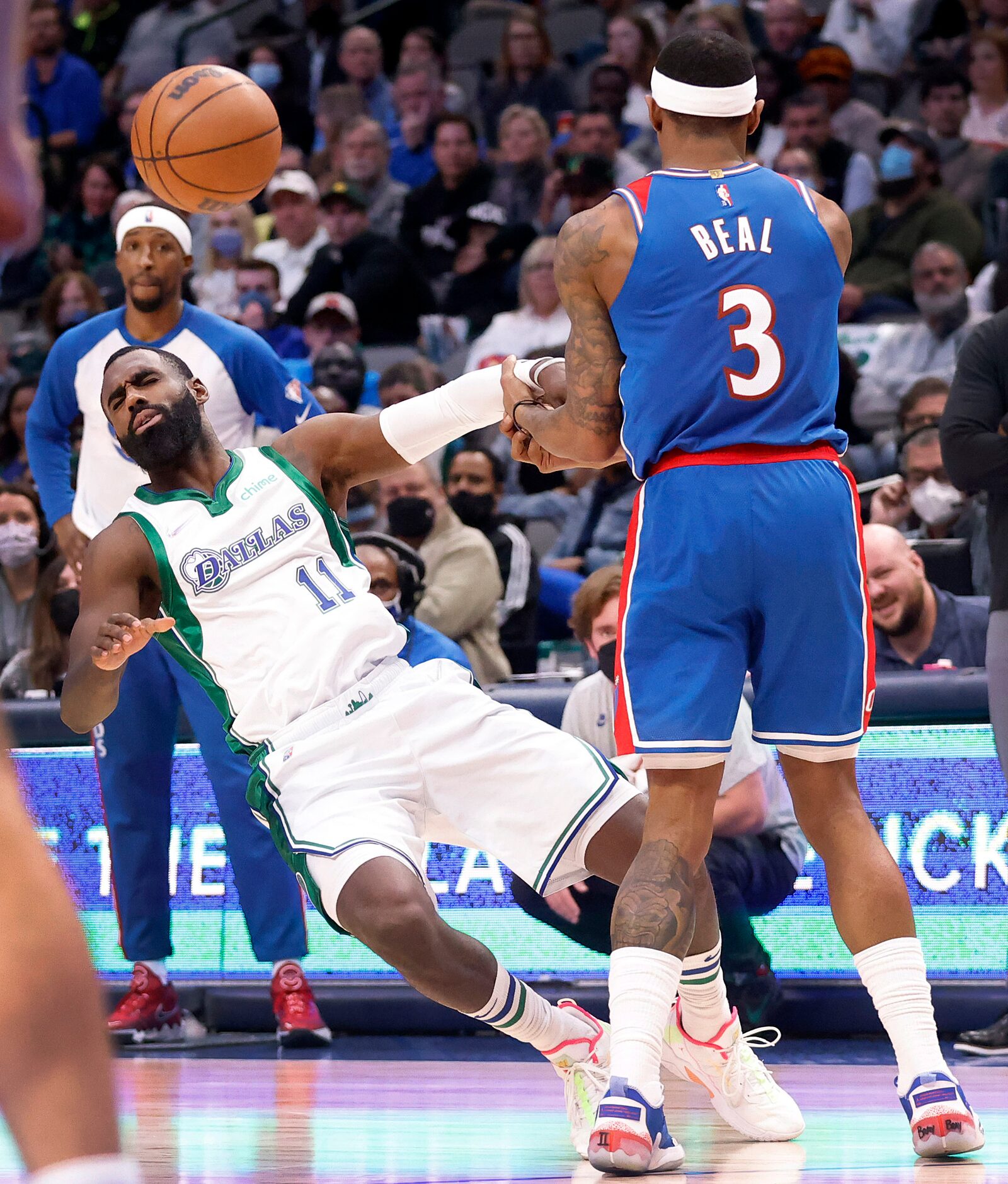 Dallas Mavericks forward Tim Hardaway Jr. (11) recoils after running into Washington Wizards...