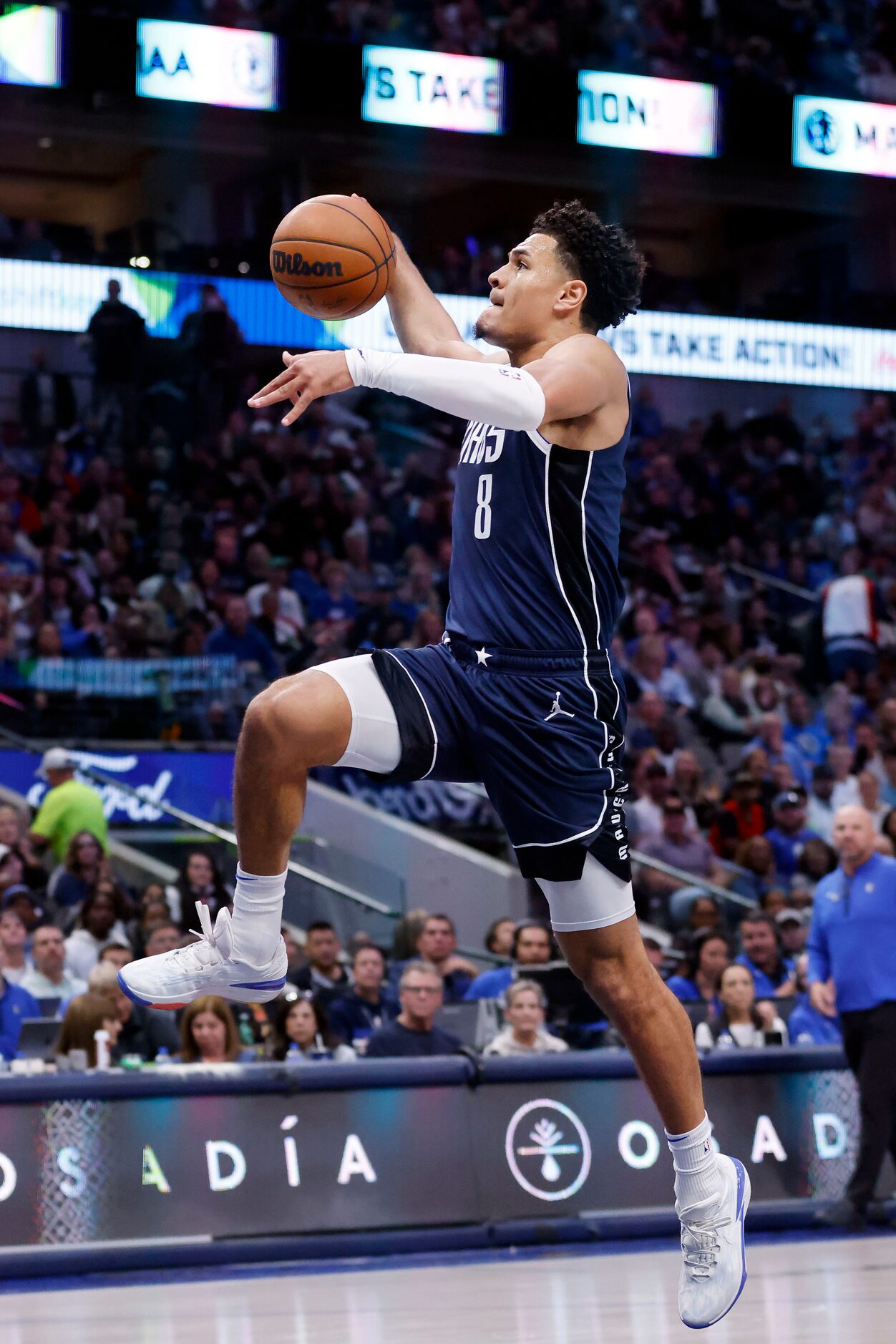 Dallas Mavericks guard Josh Green (8) leaps to the rim for a breakaway dunk in the first...