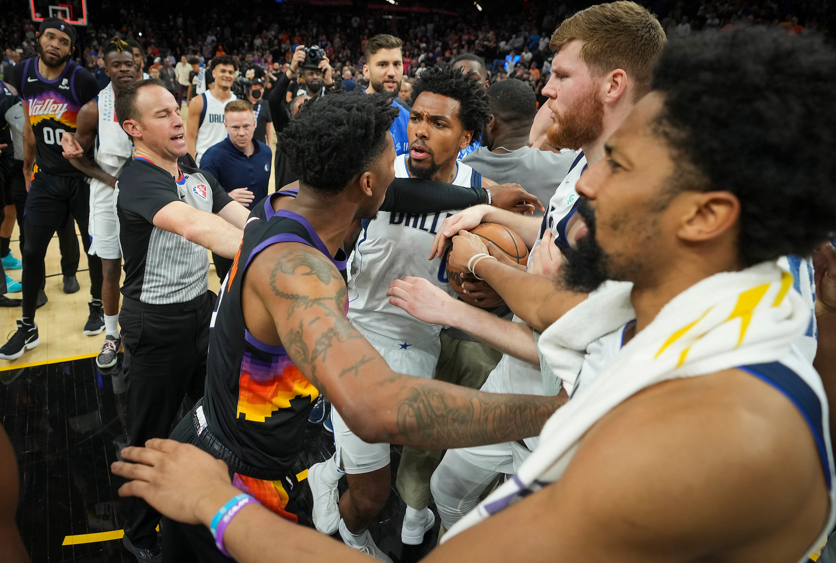 Referees try to separate Dallas Mavericks forward Sterling Brown (0) and Phoenix Suns guard...