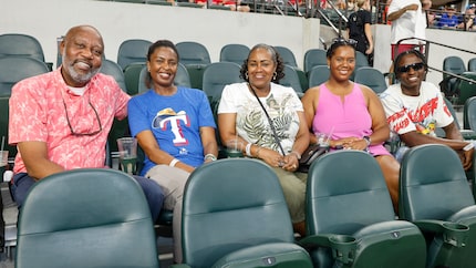 Jeffrey Walcott, father of Texas Rangers prospect Sebastian Walcott (from left), sits with...