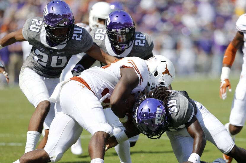 Texas Longhorns running back D'Onta Foreman (33) is tackled by TCU Horned Frogs safety...