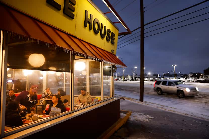 Jimmie Sloan poured a hot cup of coffee for diners keeping warm inside a Waffle House on...