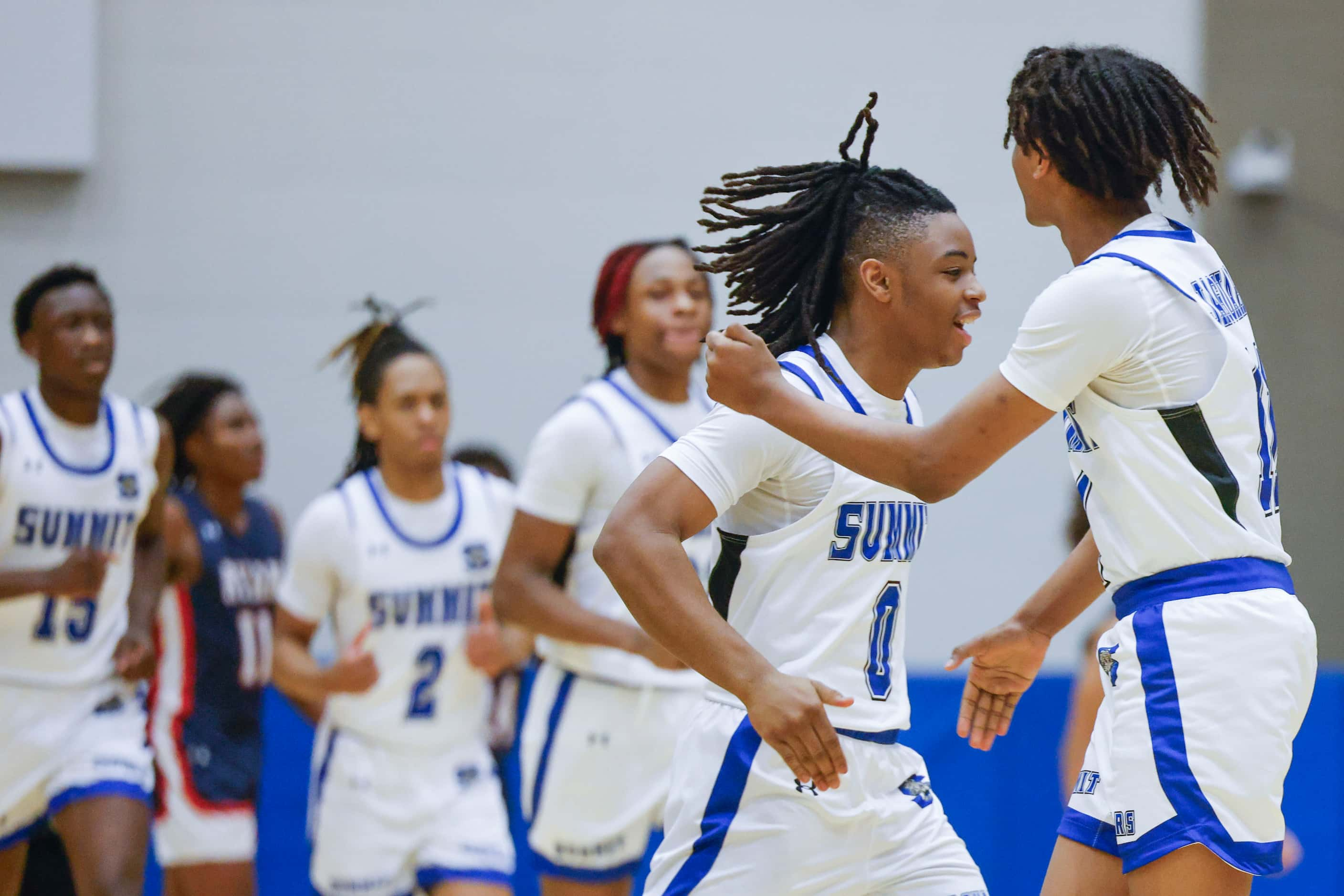 Mansfield Summit’s Derrick Brown celebrates a three-pointer with his teammates against...