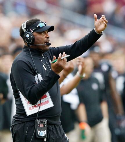 Texas A&M Aggies head coach Kevin Sumlin communicates to his players during the second half...