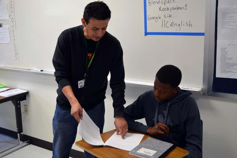 
Rocky Salmon, an English teacher at Lewisville Learning Center, gives Jermont Tigner Jr.,...