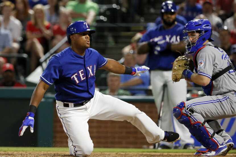 Texas Rangers' Adrian Beltre spins on the ground after losing his bat and striking out to...