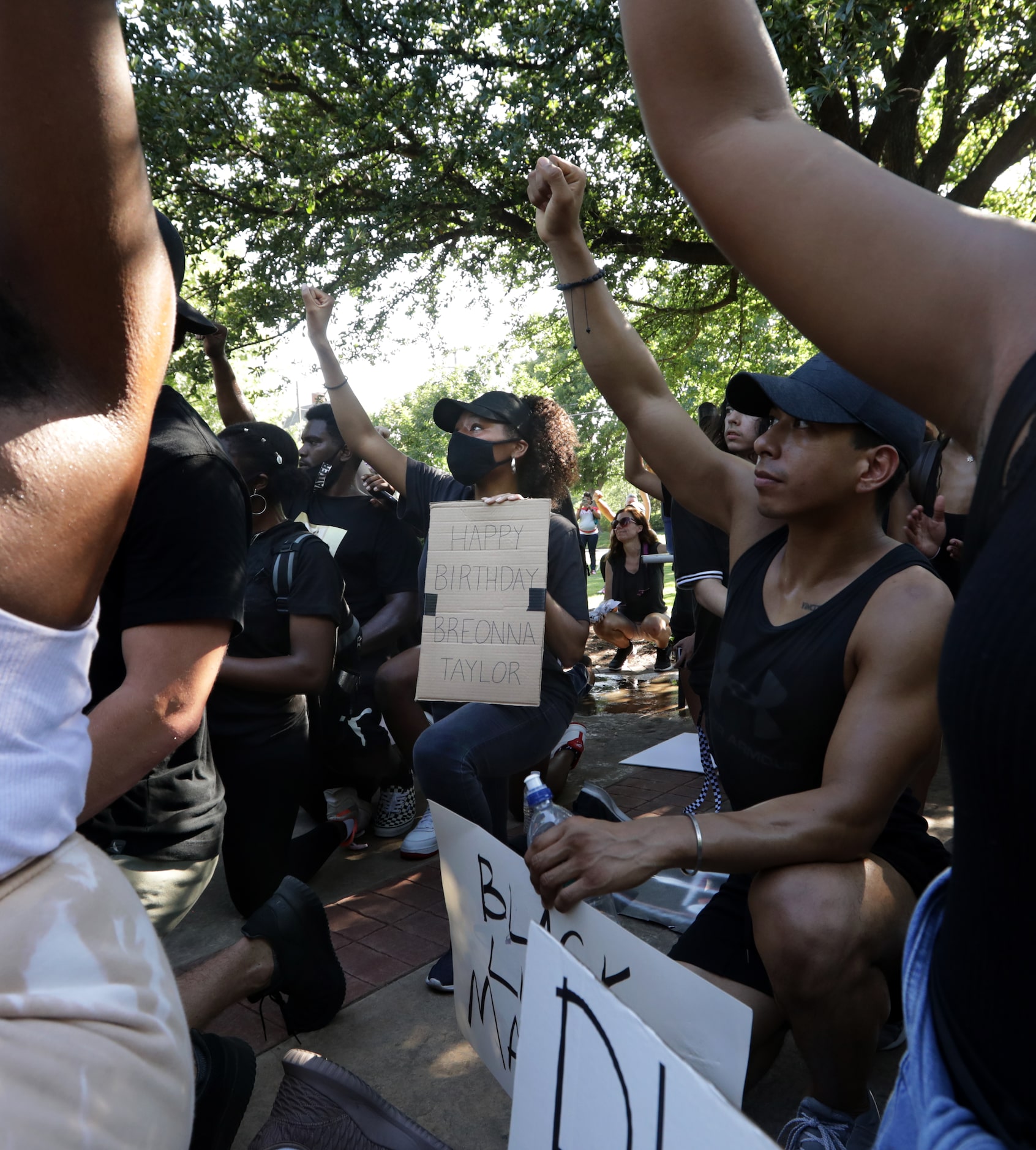 Alexia Bailey holds a Breonna Taylor sign as protestors march on the historic town square in...