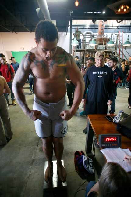 Greg Hardy flexes while standing on the scales at the Feb. 15 weigh-in for a Legacy Fighting...