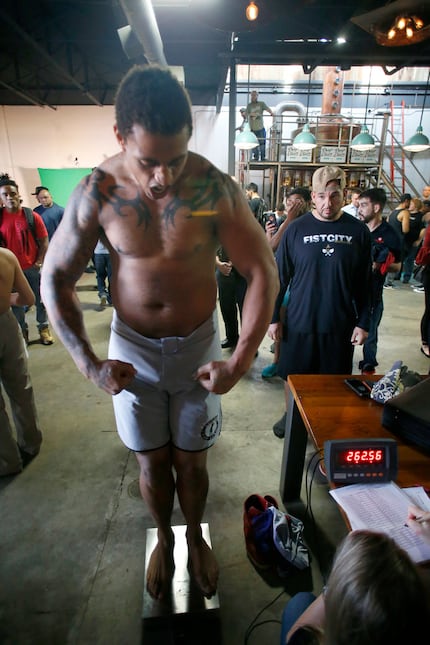 Greg Hardy flexes while standing on the scales at the Feb. 15 weigh-in for a Legacy Fighting...