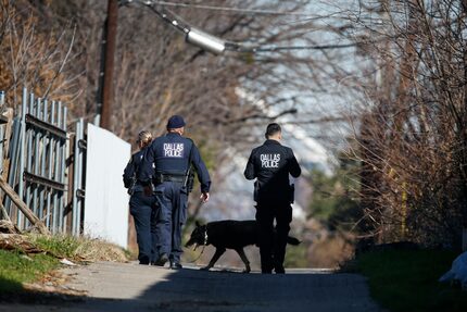 Dallas police work a crime scene in the 400 block of East Ninth Street near Adamson High...