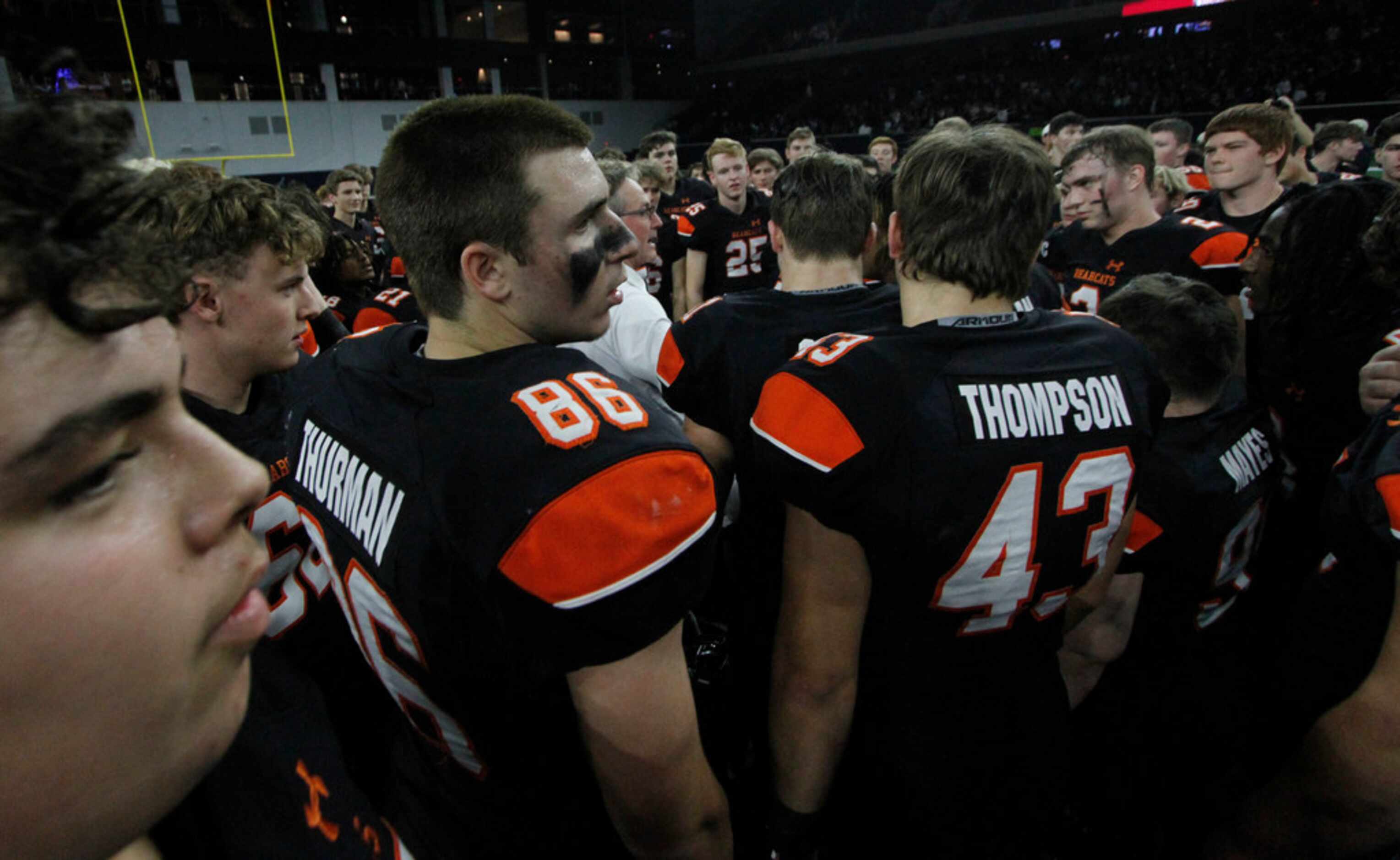 Aledo players gather around head coach Tim Buchanan for post game comments following their...